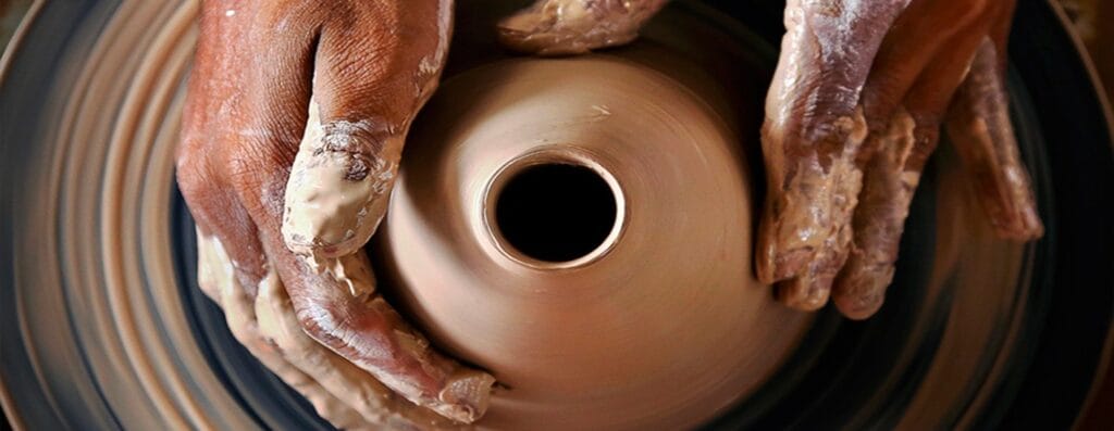 Master potter throwing large order on the potter wheel